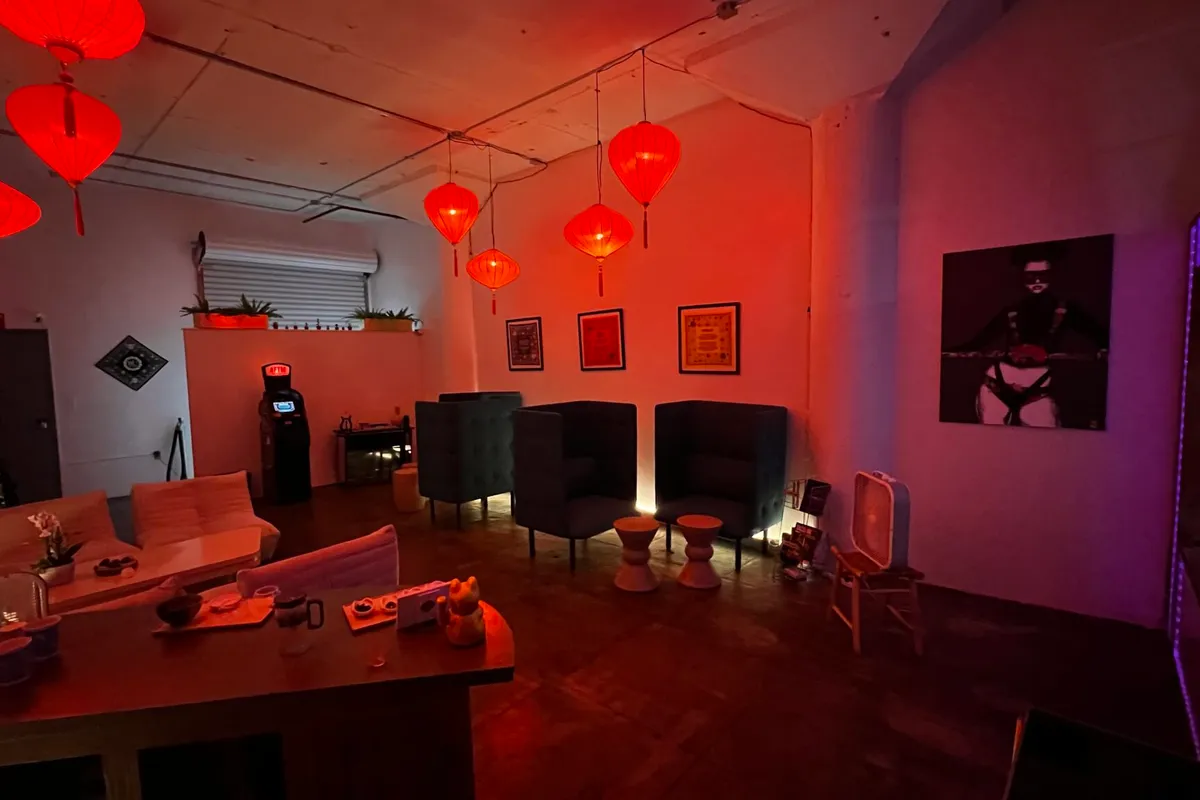 Bu Tea Den — lounge chairs, AFTM machines, and ambient red lighting